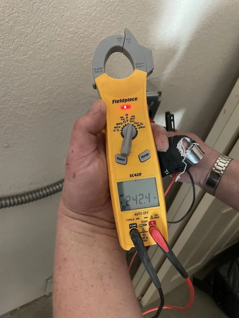Voltage testing with clamp meter during Recessed Lighting Installation in Cleveland